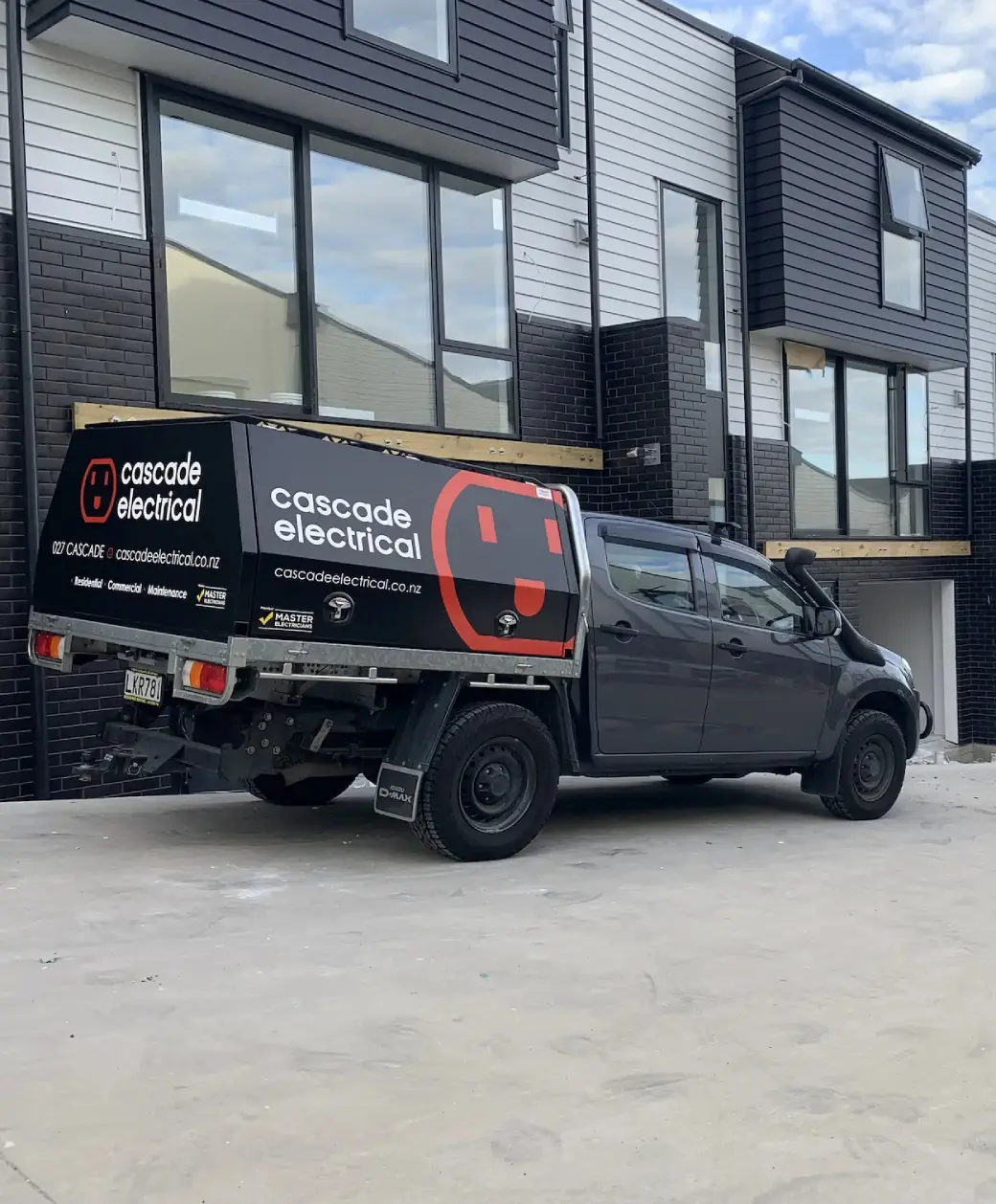 Cascade Electrical ute outside modern Auckland homes